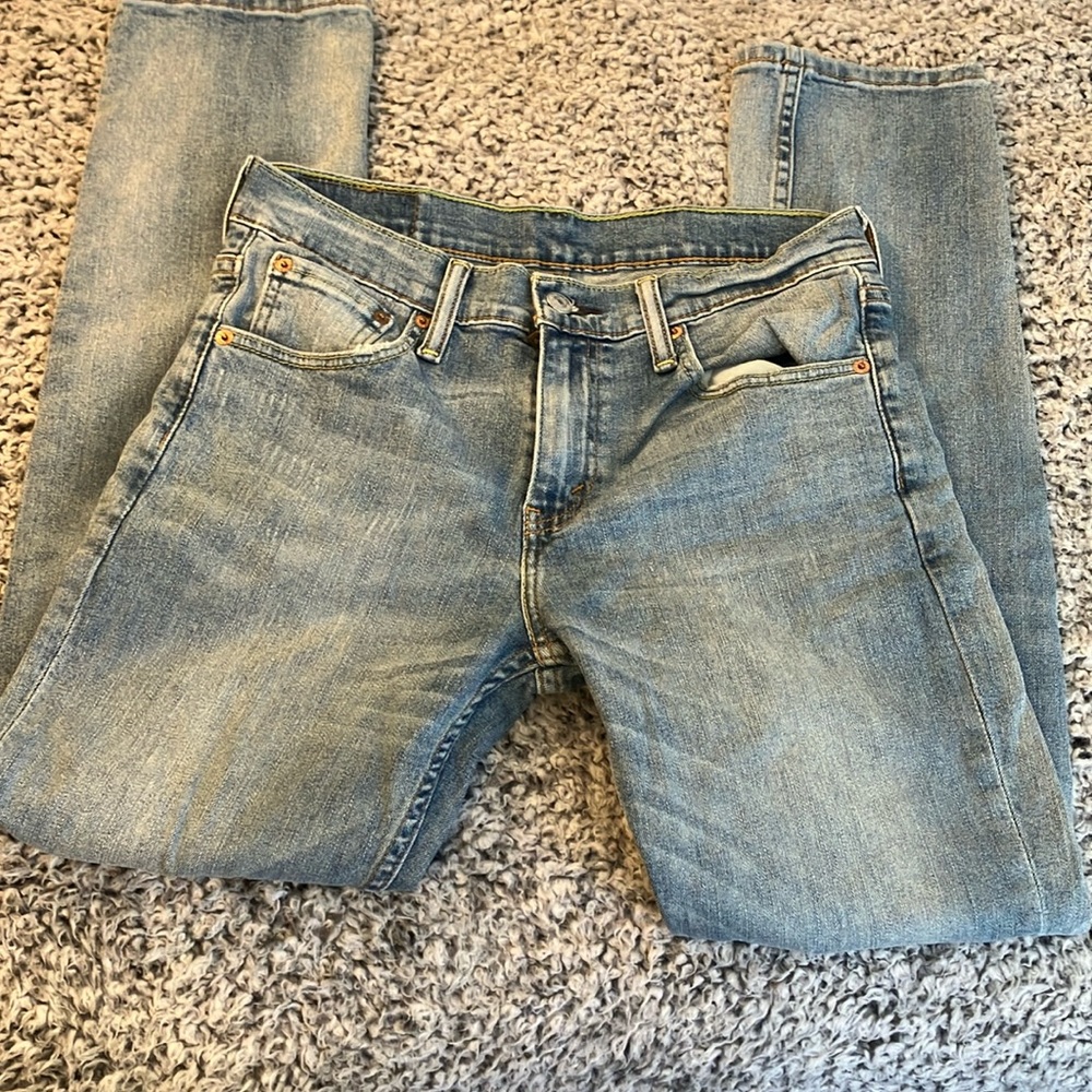 Levi’s 511 distressed and patches light wash jeans